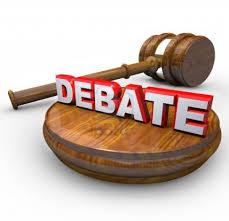 A wooden block and judge's gavel with the command DEBATE