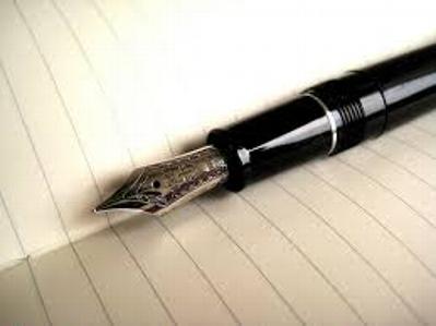 This is a photo of an open journal with a blank page and waiting fountain pen.